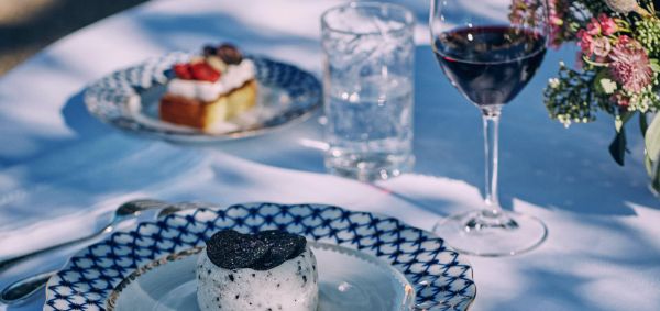 Gourmet dishes and glasses of red wine on a table